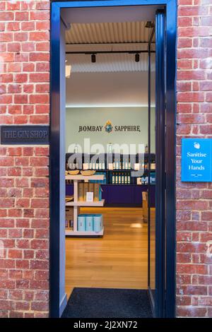 Entrance to the Gin Shop at Bombay Sapphire Gin Distillery, Laverstoke Mill, Laverstoke, Hampshire, UK in March with Sanitise Your Hands notice Stock Photo