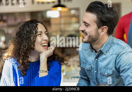 Happy couple of lover - Funny situation with both man and woman looking into each eyes - Relationship concept with boyfriend and girlfriend at first d Stock Photo