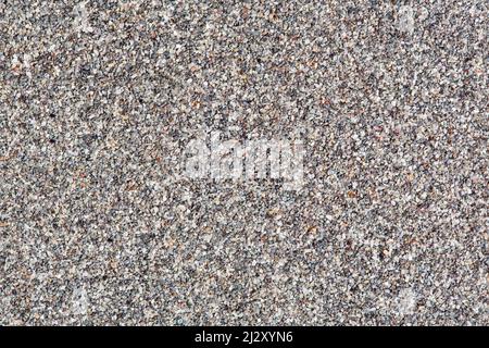 White noise gritty sandy grunge textured, small stones background. Stock Photo