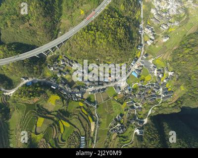 (220404) -- CHANGSHA, April 4, 2022 (Xinhua) -- Aerial photo taken on March 28, 2022 shows the view of Xingfu Village in Xiangxi Tujia and Miao Autonomous Prefecture, central China's Hunan Province. The Aizhai Bridge which opened to traffic ten years ago in central China's Hunan Province has boosted local tourism and seen income increases of local villagers.   TO GO WITH 'Across China: Aizhai Bridge becomes road to prosperity for local villagers' (Xinhua/Zhao Zhongzhi)