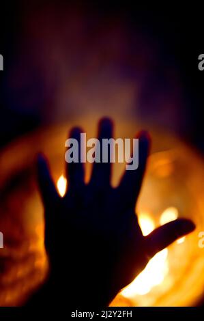 Hand Over Fire dark hand over the fire Stock Photo - Alamy