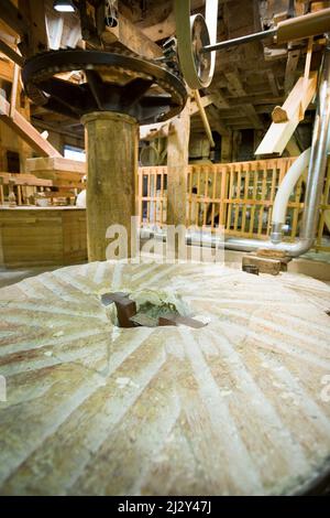 Old English flour mill. The millstone and mechanism from a historic old English water powered mill. Stock Photo