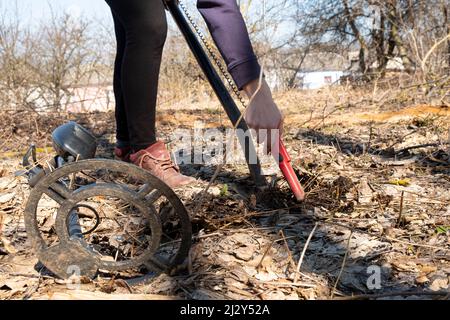 search for military things from the war times with a metal detector and a pinpointer. Stock Photo