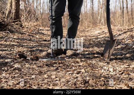 man search coins along old roads using a metal detector. Stock Photo