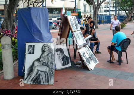 People on the Malecon 2000 have their portraits drawn in caricature style. Guayaquil Ecuador Stock Photo