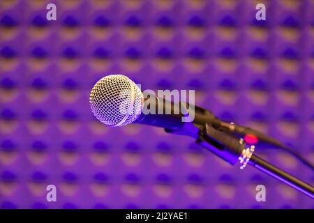 Close up on a professional microphone or mic in a recording studio for music or vocal amplification and broadcast of the audio and sound Stock Photo