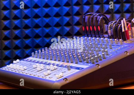 High angle of professional sound mixer control with lot of switches placed in modern recording studio Stock Photo