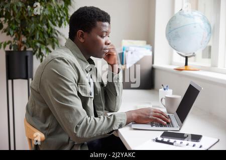 Young Man Business Entrepreneur Working From Home On Laptop Stock Photo