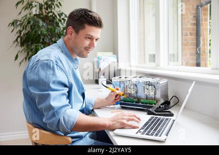 Man Fixing Electric Toaster Using Online Instructions Rather Than Buying New Product Sustainable Lifestyle Stock Photo