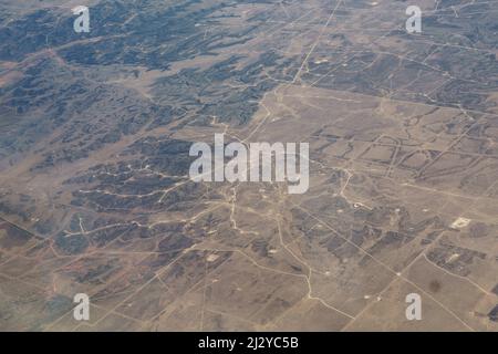 Aerial view of Field of West Texas Gas and Oil Fracking Pads and Wind Turbines, Resource Extraction Texas. Stock Photo