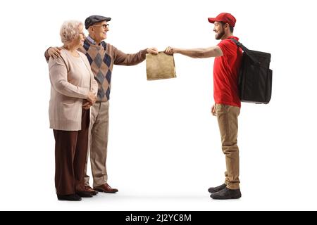 Full length profile shot of a guy delivering takeaway food bag to an elderly couple isolated on white background Stock Photo