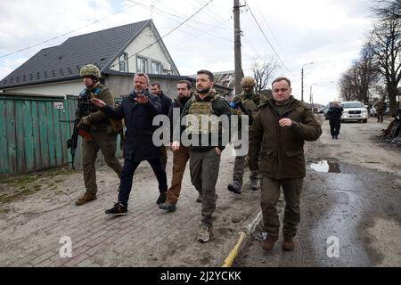 President of Ukraine Volodymyr Zelenskyy visited the city of Bucha in the Kyiv region, where mass killings of civilians took place during the occupation by Russian troops. Zelenskyy visited the humanitarian aid center and talked to local residents, on April 04, 2022. Bucha Mayor Anatoliy Fedoruk told the President about the humanitarian situation in the city, the progress of the search for the bodies of the dead, the assessment of the damage caused by the occupiers to private and communal property, and the pace of reconstruction of the city. Volodymyr Zelenskyy awarded Anatoliy Fedoruk with th Stock Photo