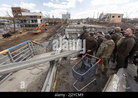 President of Ukraine Volodymyr Zelenskyy visited the city of Bucha in the Kyiv region, where mass killings of civilians took place during the occupation by Russian troops. Zelenskyy visited the humanitarian aid center and talked to local residents, on April 04, 2022. Bucha Mayor Anatoliy Fedoruk told the President about the humanitarian situation in the city, the progress of the search for the bodies of the dead, the assessment of the damage caused by the occupiers to private and communal property, and the pace of reconstruction of the city. Volodymyr Zelenskyy awarded Anatoliy Fedoruk with th Stock Photo