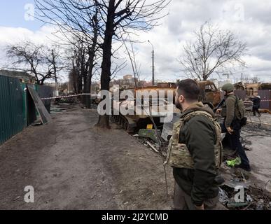 President of Ukraine Volodymyr Zelenskyy visited the city of Bucha in the Kyiv region, where mass killings of civilians took place during the occupation by Russian troops. Zelenskyy visited the humanitarian aid center and talked to local residents, on April 04, 2022. Bucha Mayor Anatoliy Fedoruk told the President about the humanitarian situation in the city, the progress of the search for the bodies of the dead, the assessment of the damage caused by the occupiers to private and communal property, and the pace of reconstruction of the city. Volodymyr Zelenskyy awarded Anatoliy Fedoruk with th Stock Photo