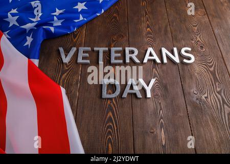 The Words Veterans Day Laid With Silver Metal Letters On Wooden Board 