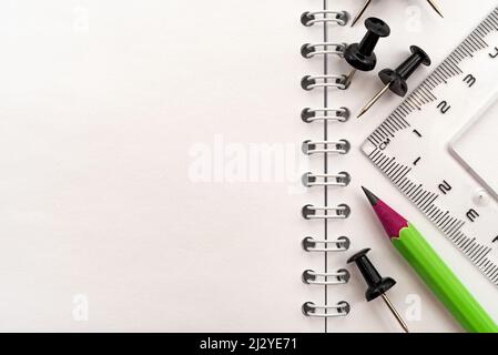 The pencil lies on a notebook with garbage after it has been sharpened. Place for an inscription or drawing. Stationery Stock Photo