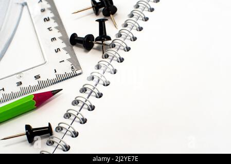 The pencil lies on a notebook with garbage after it has been sharpened. Place for an inscription or drawing. Stationery Stock Photo