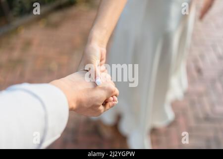 Bride groom holding hands with love on the wedding day Stock Photo