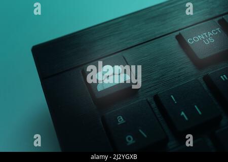 Keyboard with Conctact Us button. Internet of things. Global conection. Contact us or Customer support concept. Stock Photo