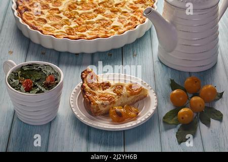 Delicious open cherry plum pie in a baking dish Stock Photo
