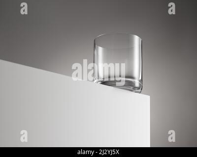 Empty whiskey glass ready to be filled with booze on white wooden cube. Hard drink concept. Stock Photo