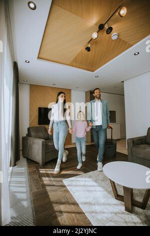 Happy young family arrive into hotel room Stock Photo