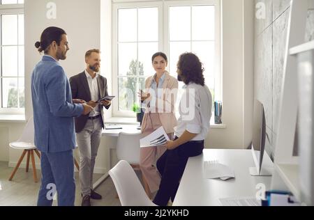 Business partners in office discuss and analyze business plan of new future project. Stock Photo