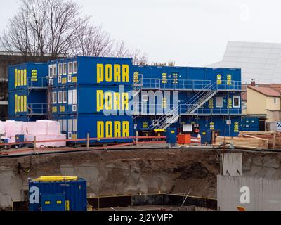 Porr company construction cabins stacked on each other at a construction site in the city. Blue container for workers and materials on the ground. Stock Photo