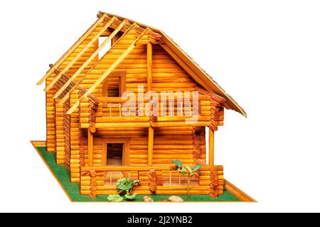 Wooden logs as a building material for a country two story house in the form of a layout. The image is isolated on a white background. Stock Photo