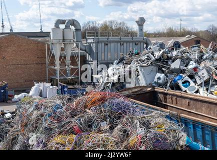A scrape metal yard full of used metal parts waiting to be recycled. Stock Photo