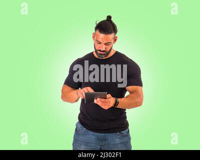 Attractive muscular man using electronic tablet in studio Stock Photo