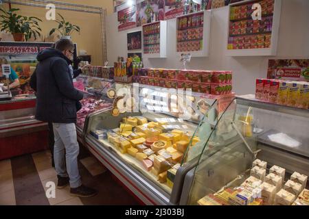 Moscow, Russia. 3rd of April, 2022. A visitor chooses cheese in the Belarusian grocery shop on the territory of Exhibition and Trade Center of the Republic of Belarus (Pavilion No.18) on VDNKh in Moscow, Russia Stock Photo