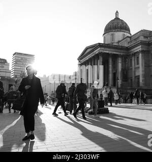 Pedestrians and tourists outside The National Gallery in Trafalgar Square. Monochrome. London. Stock Photo