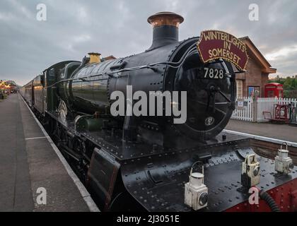 Locomotive 7828 Odney Manor pulling the illuminated 'Winter Lights' Christmas special passenger train on the West Somerset Railway at Bishops Lydeard. Stock Photo