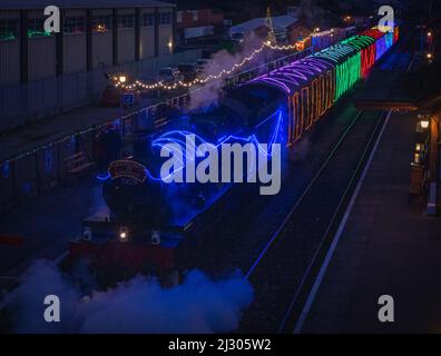 Locomotive 7828 Odney Manor pulling the illuminated 'Winter Lights' Christmas special passenger train on the West Somerset Railway at Bishops Lydeard. Stock Photo