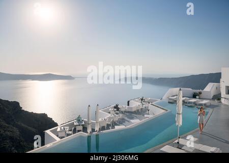 Hotel pool with view from Fira to the caldera of Santorini, Santorin, Cyclades, Aegean Sea, Mediterranean Sea, Greece, Europe Stock Photo