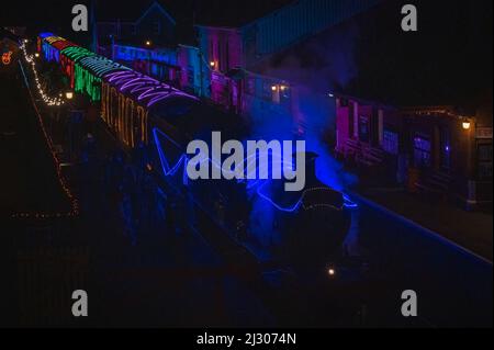 Locomotive 7828 Odney Manor pulling the illuminated 'Winter Lights' Christmas special passenger train on the West Somerset Railway at Bishops Lydeard. Stock Photo