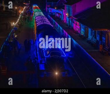 Locomotive 7828 Odney Manor pulling the illuminated 'Winter Lights' Christmas special passenger train on the West Somerset Railway at Bishops Lydeard. Stock Photo