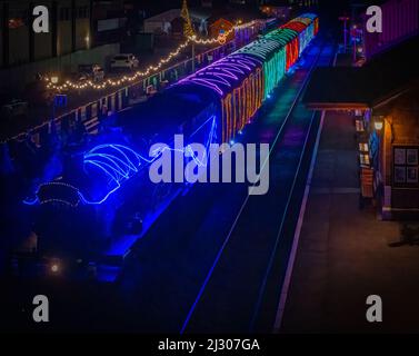 Locomotive 7828 Odney Manor pulling the illuminated 'Winter Lights' Christmas special passenger train on the West Somerset Railway at Bishops Lydeard. Stock Photo