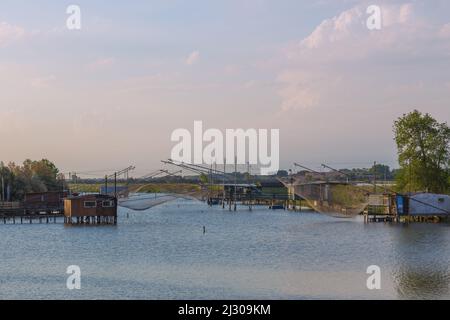 Comacchio, Porto Garibaldi, Canale Torre Rossa with fishermen&#39;s huts and outrigger nets Stock Photo