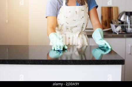 Hygiene equals happiness. Shot of a unrecognizable female cleaning the counter at home. Stock Photo
