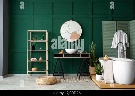 Interior of stylish bathroom with sink, mirror and shelving unit Stock Photo
