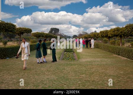 Agra, India.  Indians Stroll in the Mehtab Bagh Gardens, across the Yamuna River from the Taj Mahal. Stock Photo