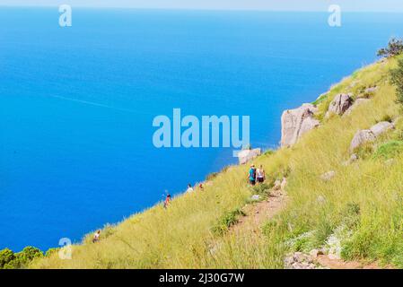People walking on La Rocca trail, Cefalu, Sicily, Italy, Europe Stock Photo