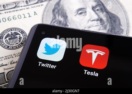Twitter and Tesla apps seen on the corner of smartphone. Concept for Elon Musk buying shares of Twitter. Stafford, United Kingdom, March 4, 2022. Stock Photo