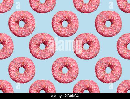 Pink glazed doughnuts with icing on light blue backdrop Stock Photo
