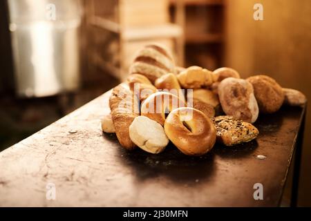 Theres a lot to choose from. Closeup shot of a selection of freshly baked bread on a wooden table. Stock Photo