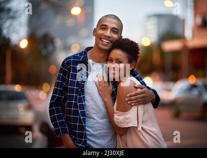 We love being out on the town. Cropped portrait of an affectionate young couple out on a date in the city. Stock Photo