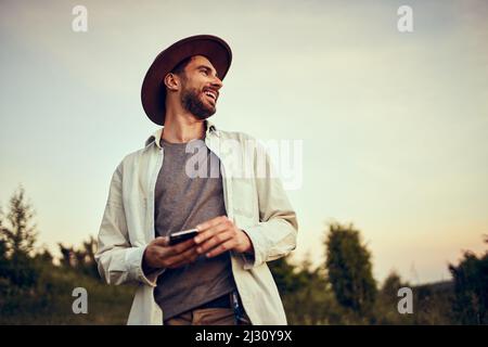 Happy young man laughing enjoying outdoor walk in the evening Stock Photo