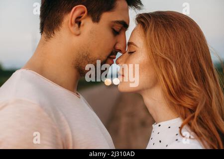 Loving couple standing closeness with closed eyes posing. Beautiful portrait for lifestyle design. High quality photo Stock Photo